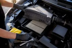 Technician opening an engine air filter housing