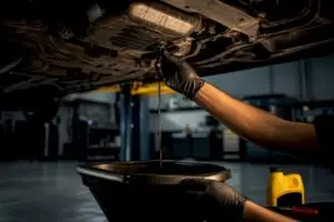 Technician performing an automotive oil change