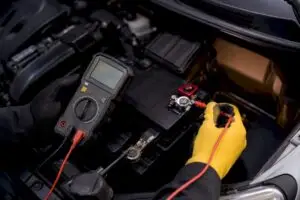Technician testing battery parasitic draw