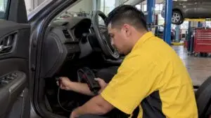 Technician performing an OBD readiness scan