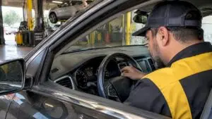 Technician diagnosing a blinking TPMS warning