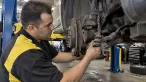Technician checks a vehicle's tie rod joint