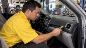 Technician checking a car heater vent