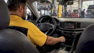 Technician testing a car’s gear engagement