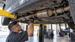 Catalytic converter mounted beneath a raised sedan